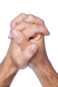 Closed up shot of praying hands isolated in a white background