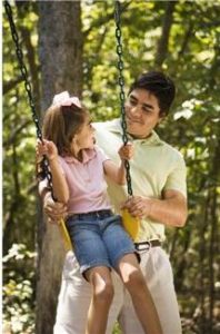 Dad with child on swing