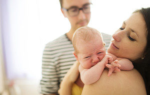 young adoptive family: dad, mom, newborn