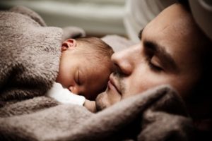 Dad with baby sleeping