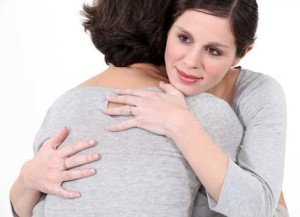 young woman hugging older woman