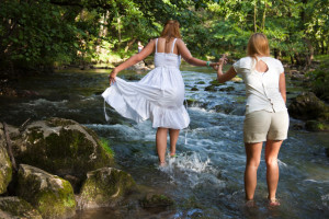 2 girls crossing stream together