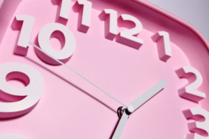 close up of a pink clock face